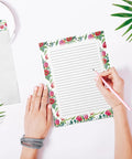 Person writing on Vintage Airmail Themed Stationery Set With 100 Pieces Letter Size 8.5 By 11 Inches Including 50 Lined Sheets And 50 Matching Envelopes Double Sided Lined Paper On 27 Pound Bond And 32 Pound Offset Envelopes For Your Home Office Desk with floral design
