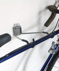 Heavy Duty Bike Wall Mount With EVA Foam Padding And 50lb Capacity holding blue bike on wall, sturdy steel construction