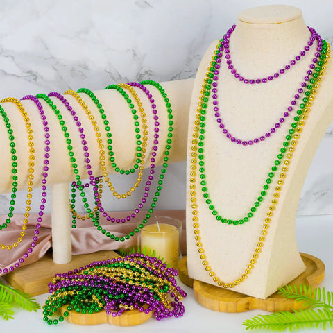 Mardi Gras Beads Necklaces 24 Pack, 33 Inch Round Beads In Green Purple Gold displayed on stands, carnival party favors
