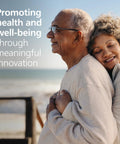 Philips HeartStart Home AED Defibrillator, Value Package: older couple embracing on a beach; beige clothing.