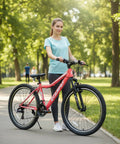 Woman with a 24 Inch Female Mountain Bike With Dual V Brakes 21 Speed Shifter High Carbon Frame And Front Suspension Fork in park