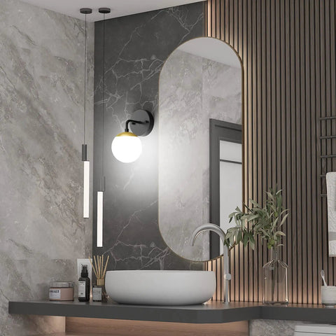 Bathroom with Black And Gold Globe Wall Sconce Mid Century Modern One Light Fixture beside mirror, 6000K G9 bulbs included.