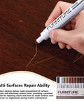 Using a pen from the 12 Color Furniture Scratch Repair Markers Kit With Wood Touch Up Stain Pen for repairing a scratch on wood