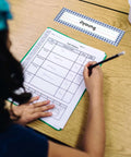 Child writing at desk with Farmers Market Desk Labels For Kids 36 Pack Name Tags For Desks And Lockers Classroom Organization visible.