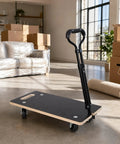 Beefy 440 Pound Heavy Duty Phenolic Resin Faced Plywood Moving Dolly With Telescopic Handle And 3 Inch PP Wheels For Heavy Appliances, Furniture, Pianos, And Large Loads, Durable, Stable, Easy Glide. Black plywood dolly with handle in a room.