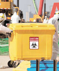 Heavy Duty Self Adhesive Biohazard Warning Decals Waterproof Toxic Waste Stickers on yellow biohazard waste container in use.
