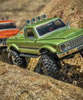 Badass 1/18 Scale RC Crawler With Slick Shifting Two Speed Transmission And Bulletproof Metal Gears Nasty Terrain Rock Climbing Rig Trail Smashin Setup Drop In Ready Convoy Medium Olive Green on rocky terrain.