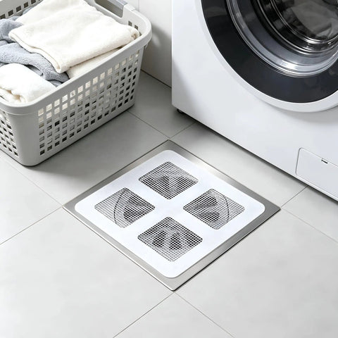 Hair Drain Stickers 100 Pcs Disposable Peel Stick applied on floor near washing machine and laundry basket.
