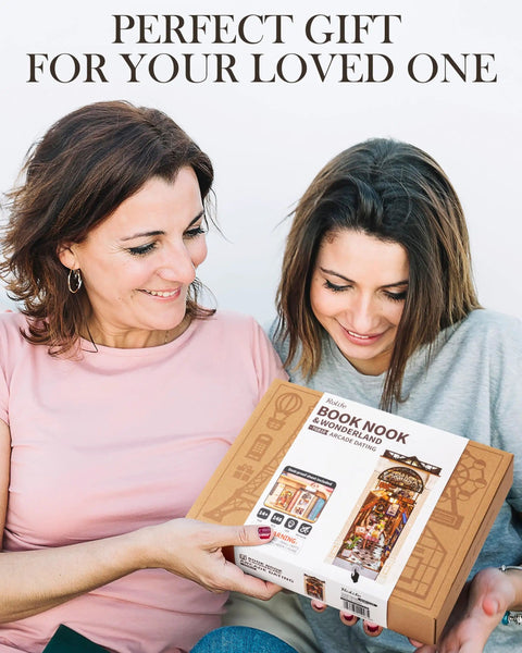 Two women holding a DIY Book Nook Kit European Arcade Street Scene With LED Lighting 3D Wooden Puzzle Miniature House box.