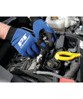 Heavy Duty Spark Plug Wire Pliers For Safe Removal used by mechanic, wearing gloves, extracting wire from engine.