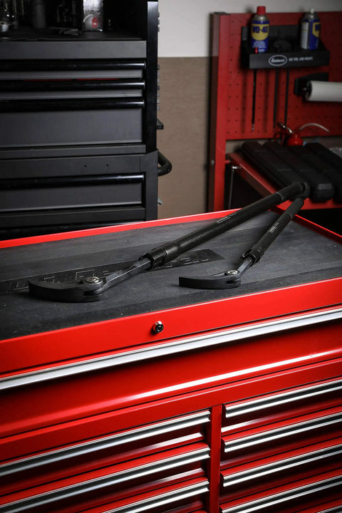 Extendable Indexing Pry Bar 29 To 48 Inch Telescoping Tough As Nails Heavy Duty Tool with 14 Position Locking resting on red toolbox