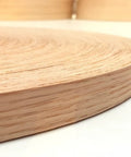 Close-up of Red Oak Wood Veneer Edge Banding Tape 2 Inch By 50 Foot Roll Pre Glued Iron On With Hot Melt Adhesive Smooth Sanded Finish
