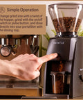 Premium Black Conical Burr Coffee Grinder Crafted For On Point Espresso Pulls Featuring Slick Micro Dial Controls A Top Shelf Build That Always Delivers The Goods For Real Coffee Heads in use, adjusting grind size.