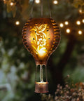 Hummingbird Hot Air Balloon Hanging Solar Lantern 1 Pack For Garden Decor with glowing brass hummingbird motif at night.
