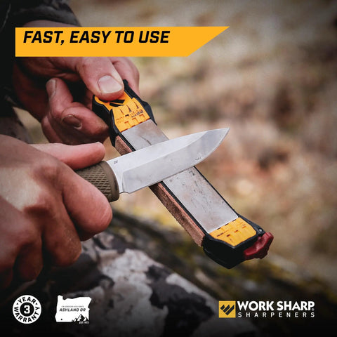Close-up of Roam Ready Guided Field Sharpener with diamond guides used for knife maintenance in hands outdoors.