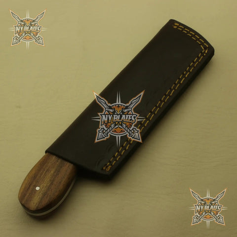 Rugged High Carbon Steel Skinner Knife With Full Tang Fixed Blade Wood Handle And Leather Sheath partially in sheath