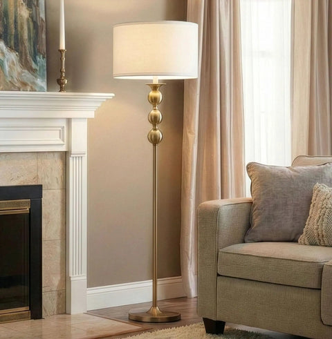 Riley 60 Inch Floor Lamp With Drum Shade In Gold Brass Finish For Living Room Or Bedroom Modern Standing Lamp Against Sofa