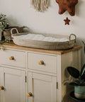 Six Pack Antique Brass Cabinet Knobs With Backplates In Zinc Alloy on a dresser in a cozy room, retro vibe decor.