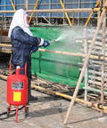 Person using Powerful 10 Gallon Sandblaster Kit With 125 PSI Pressure For Fast Paint Rust Stain Removal on metal structure
