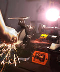 Rock Hard Bench Grinder With Eight Inch Grinding Wheels and a Snappy Variable Speed Motor sharpening metal, sparks flying.