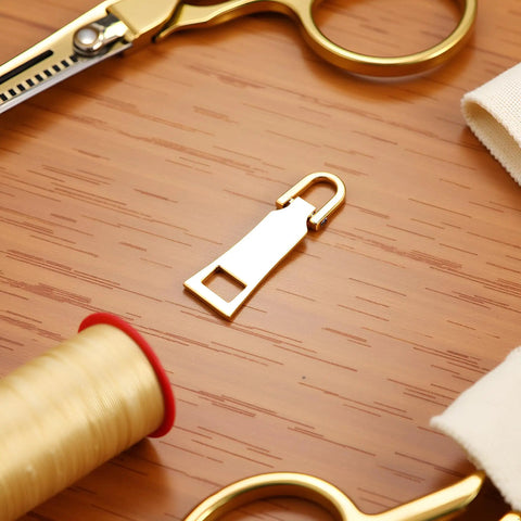 Gold Zipper Pull Replacement For Luggage Backpack Jacket Suitcase Coat Easy Slider Repair With Zipper Tab Fasteners on table