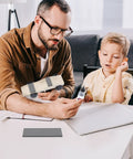 Father and son working with Pinewood Derby Weights Kit With 3 Oz Flexible Tape Weights And 0.5 Oz Graphite Lubricant For Serious Speed Boost On Derby Cars No Drilling Easy Cut Lead Free DIY Wheels And Axles