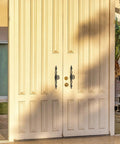 Front view of large double doors with Vintage Style Antique Bronze Long Cabinet Handles 6.3 inches, 2 pack hollow drawer pulls installed.