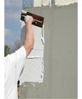 Worker using Finishing Trowel 20 By 5 Inch High Carbon Steel Blade With Curved Durasoft Handle And Xtralite Aluminum Mounting on wall