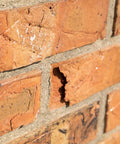 Heavy Duty Siloxane Chimney Brick Sealer Keeps The Wet Out For Good With A Clear Breathable Waterproof Coating That Shields Vertical Masonry Against Freeze Thaw Cracks For Rock Solid Dry Season Action One Gallon on damaged brick surface.