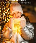 Child holding Twinkle Fairy Lights 33 Ft USB Plug In String Lights With Remote And Timer 100 LED Waterproof Wire glowing softly