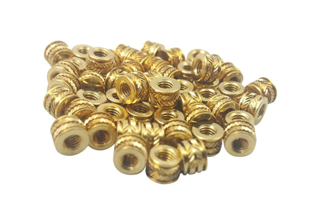 M3 0.5 Threaded Heat Set Inserts For 3D Printing Brass Threaded Inserts in a pile, gold color, visible tapered design and finned ridges