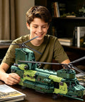 Boy assembling Motorized Military Helicopter Building Blocks Kit With 1826 Pieces Remote Control Rotor Army Airplane Model