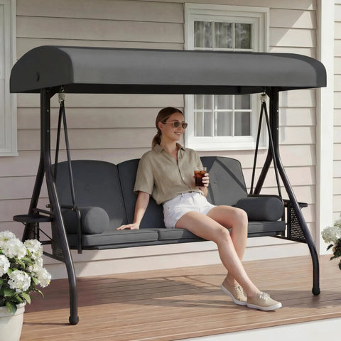 Three Seat Patio Swing With Canopy And Cup Holders, Heavy Duty Steel Frame, Weather Resistant Outdoor Swing Bench For Yard, Porch, Or Backyard, Chill With Family Or Friends In This Comfortable Three Person Grey Swing, woman sitting holding drink