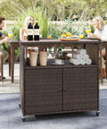 Sturdy outdoor storage cabinet on wheels with solid acacia wood frame and PE rattan finish, used as a patio buffet bar cart.