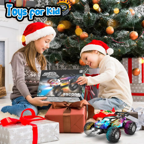 Children opening All Terrain Remote Control Monster Truck For Boys 2.4GHz RC Car With LED Body Lights Dual Rechargeable Batteries.