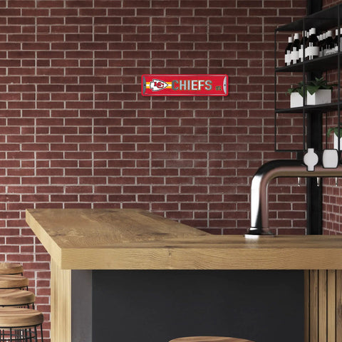 Official Kansas City Chiefs NFL Aluminum Metal Street Sign 4X15 Inch on a brick wall in a man cave.