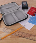 USA Gear Laser Measurement Tool Hard Case opened on wooden surface with Bosch laser measure, pencil, and ruler.