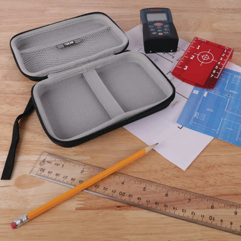 USA Gear Laser Measurement Tool Hard Case opened on wooden surface with Bosch laser measure, pencil, and ruler.