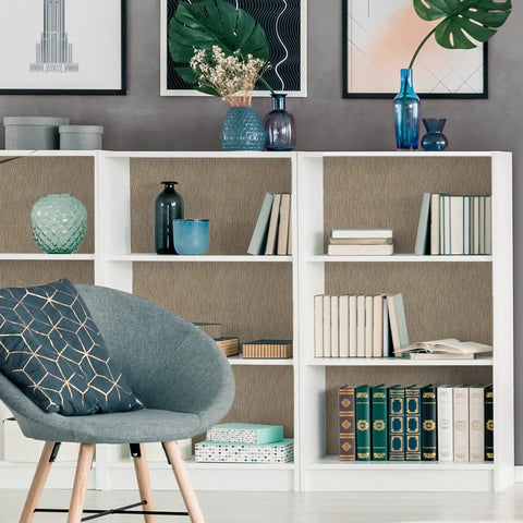 Bookshelf lined with taupe grasscloth wallpaper peel and stick 32 inch wide by 354 inch long roll self adhesive textured faux grasscloth contact paper for cabinets walls and furniture with easy install 78.46 sq ft coverage no mess removable, featuring books and decor items.