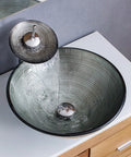 USZWBY Tempered Glass Bathroom Vessel Sink, Round Shape Spiral Pattern with waterfall faucet and pop up drain in use.