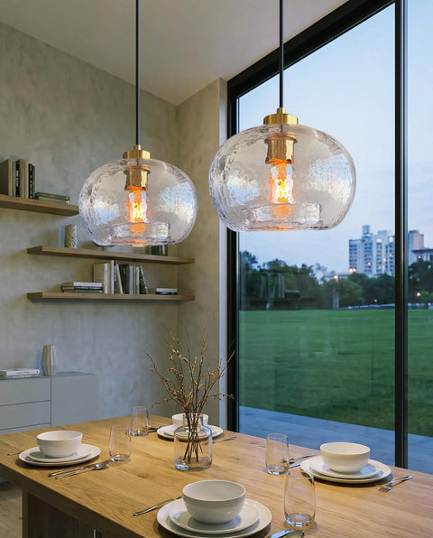 CASAMOTION Glass Pendant Lights, Textured Clear Globe Shade above a dining table in a modern setting.