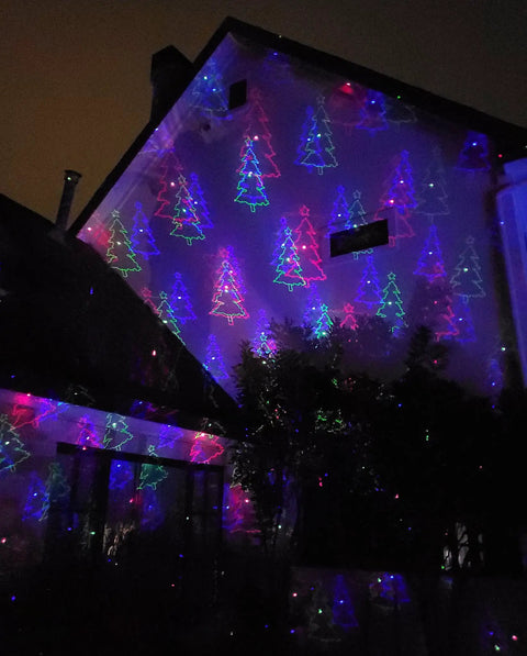 Motion Pattern Firefly 3 In 1 RGB Outdoor Laser Christmas Lights Projector With 18 Moving Patterns illuminating a house facade