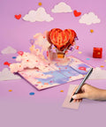Heart Hot Air Balloon 3D Pop Up Card With Dreamy Sky Scene Gift For Valentines Day Birthday Mothers Day Anniversary Thinking Of You Includes Envelope And Message Note 5x7 Card, showing open card with clouds and pen on note