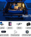 Person using 500W Car Power Inverter With 12V To 110V Conversion in car with laptop during road trip at night.