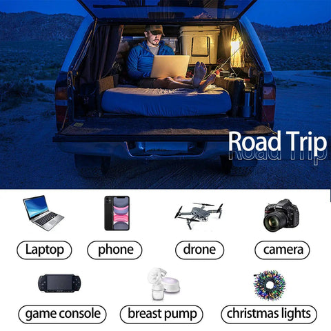 Person using 500W Car Power Inverter With 12V To 110V Conversion in car with laptop during road trip at night.