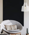 Agatha One Light Pendant In Brushed Nickel hanging over modern chair, highlighting sleek, contemporary design in home setting.