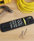 Magnetic Wristband For Tools With Fifteen Strong Magnets And Breathable Mesh on workbench holding screws and nuts