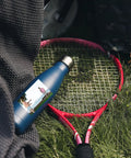 Snag Our Fly Custom 17 Oz Insulated Water Bottles With Double Wall Stainless Steel Build Plus Leak Proof Reusable Design Great For Sports Travel And Gym Workouts White Bulk 100 Pack Holds One Hundred Cups Ideal Kick Back Drinkware Vacuum Sealed on grass with tennis racket.