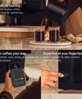 Person using Aiden Precision Coffee Maker With Thermal Carafe 10 Cup Programmable Drip Coffee Machine For Single Serve And Batch Brew Adjustable Brew Strength Removable Water Tank Matte Black, pouring coffee, adjusting settings, and customizing brew via smartphone.