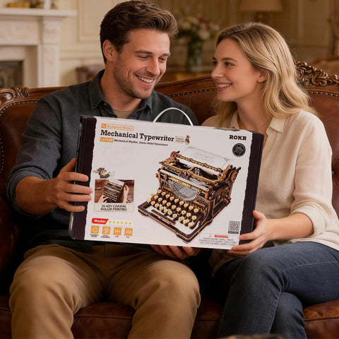 Typewriter 3D Wooden Puzzle Kit For Adults Mechanical Model Build No Batteries Gears Spin Typebars Swinging Knobs See Inside Vintage Black Style Desk Display Gift That Slaps box held by couple on sofa